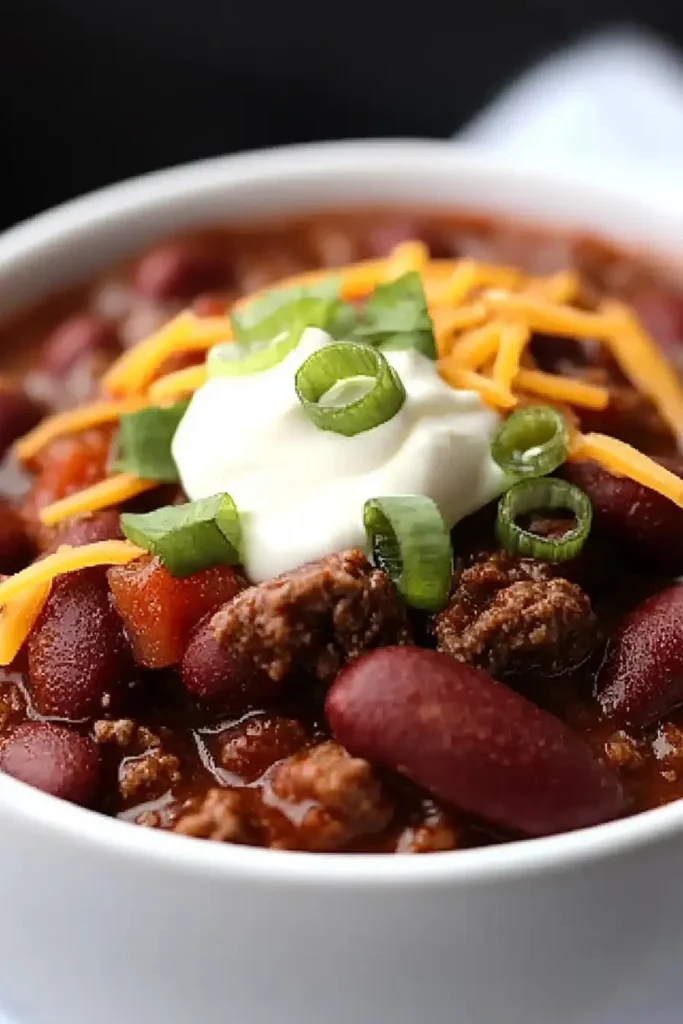 Steak and Beef Chili with Sour Cream and Green Onion Garnish